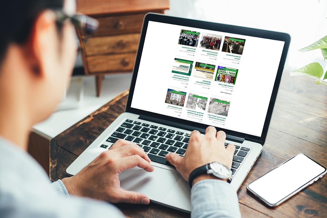 Person browsing Ohio University calendar on a laptop